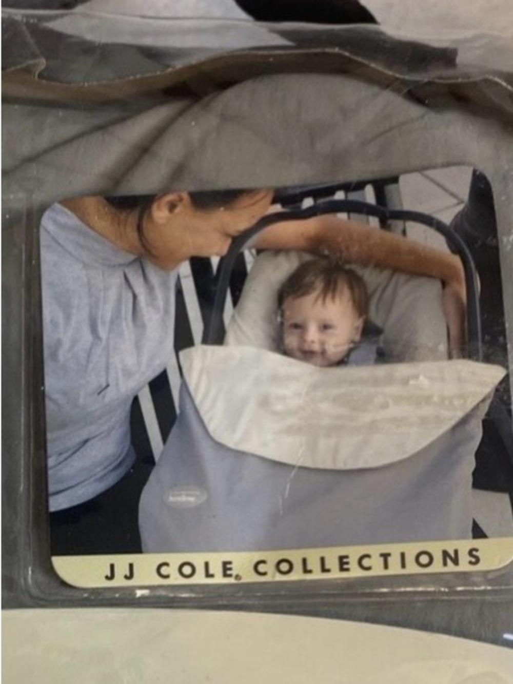 JJ Cole Bundleme lite and an aden & anais cotton muslin swaddle blanket.